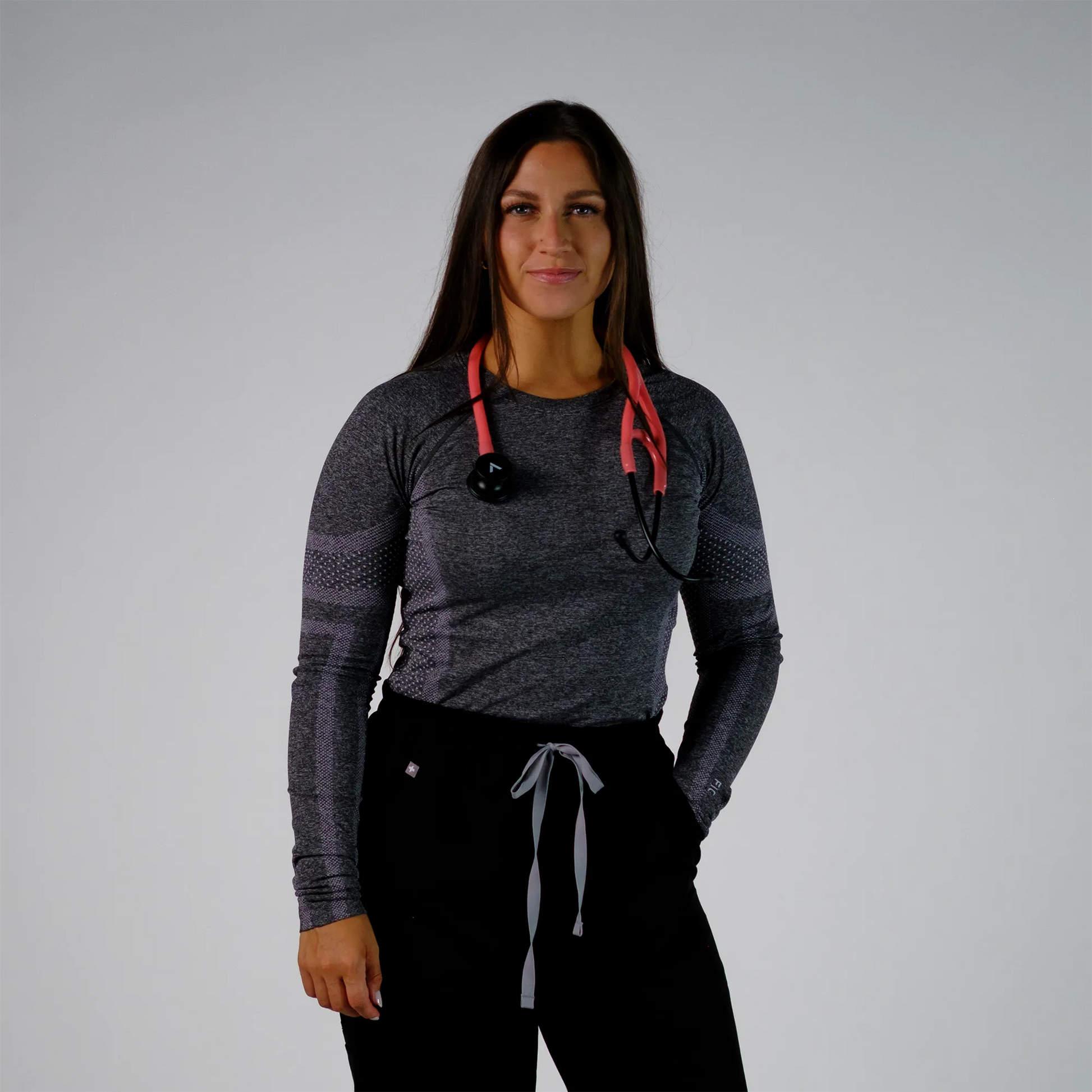model posing with a coral cardiology stethoscope
