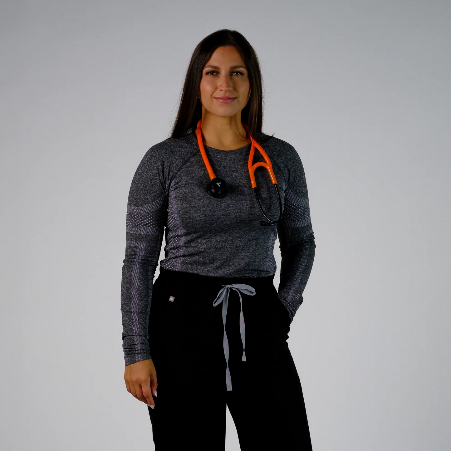 model posing with orange cardiology stethoscope
