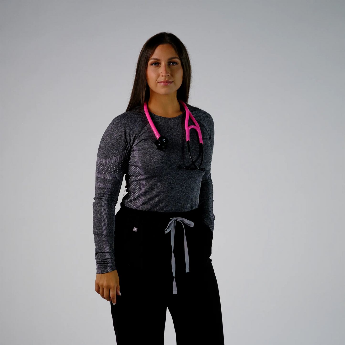 model posing with  a pink cardiology stethoscope