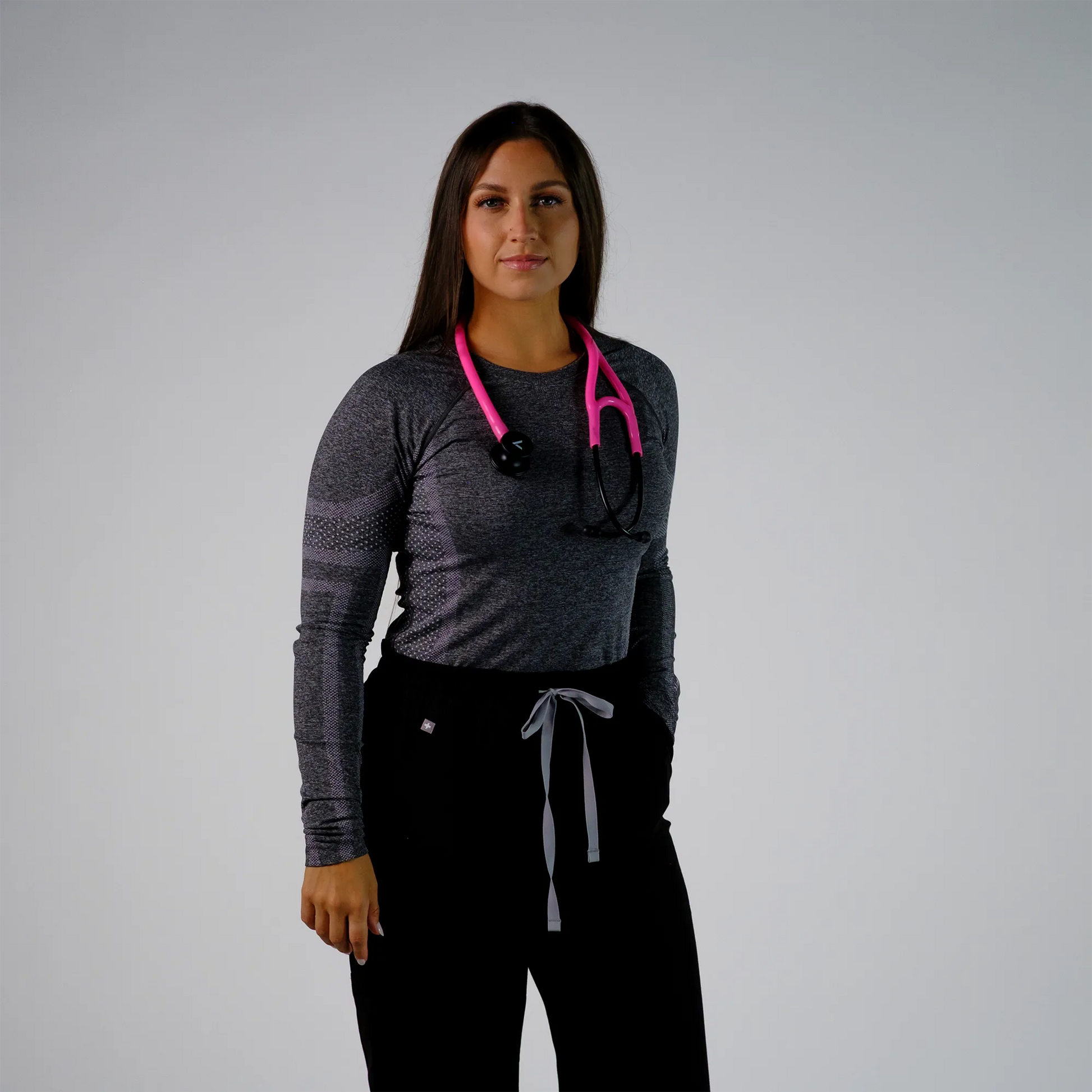 model posing with  a pink cardiology stethoscope