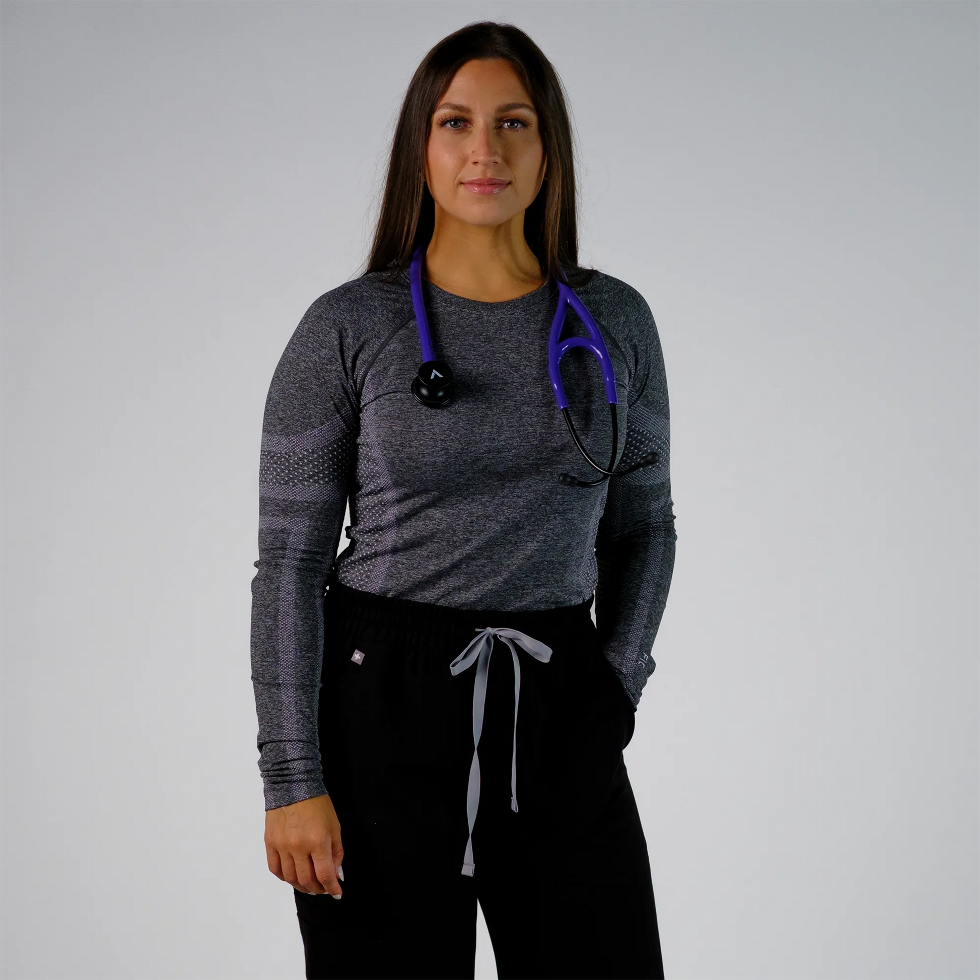 a model wearing a purple cardiology stethoscope