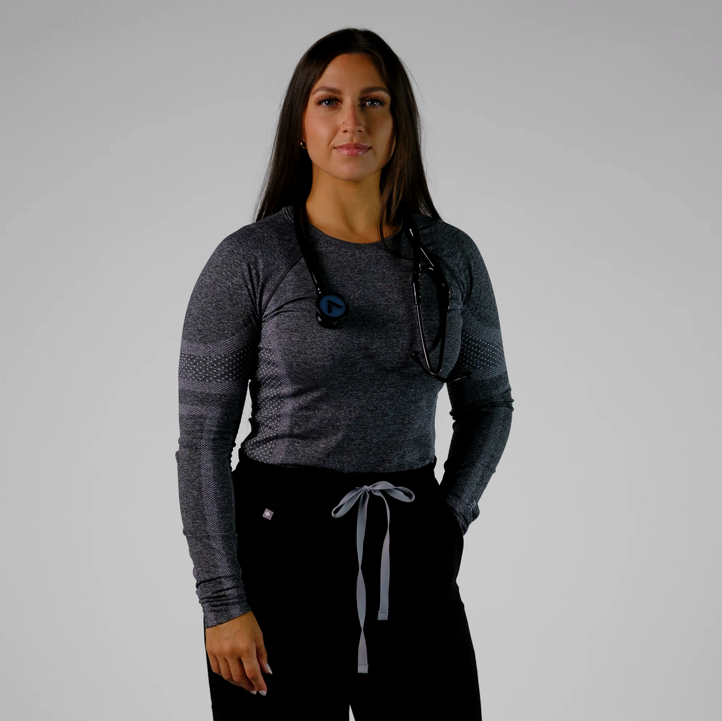 model posing with a black cardiology stethoscope
