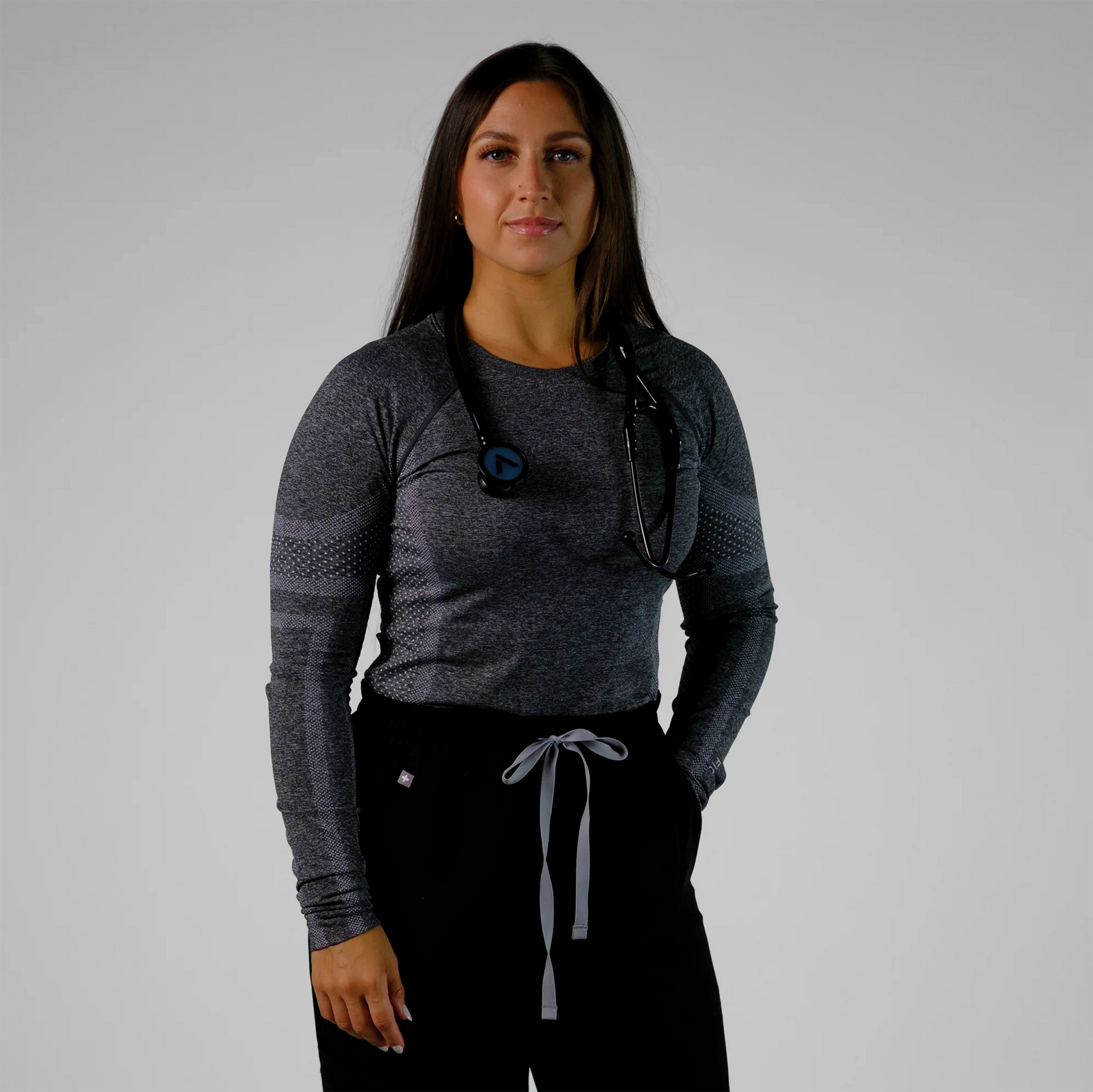 model posing with a black cardiology stethoscope