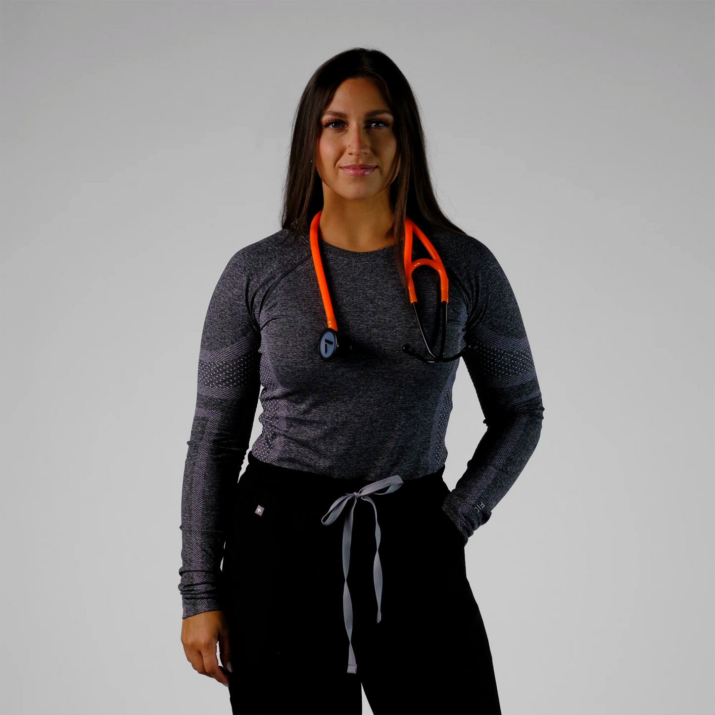 model posing with an orange cardiology stethoscope
