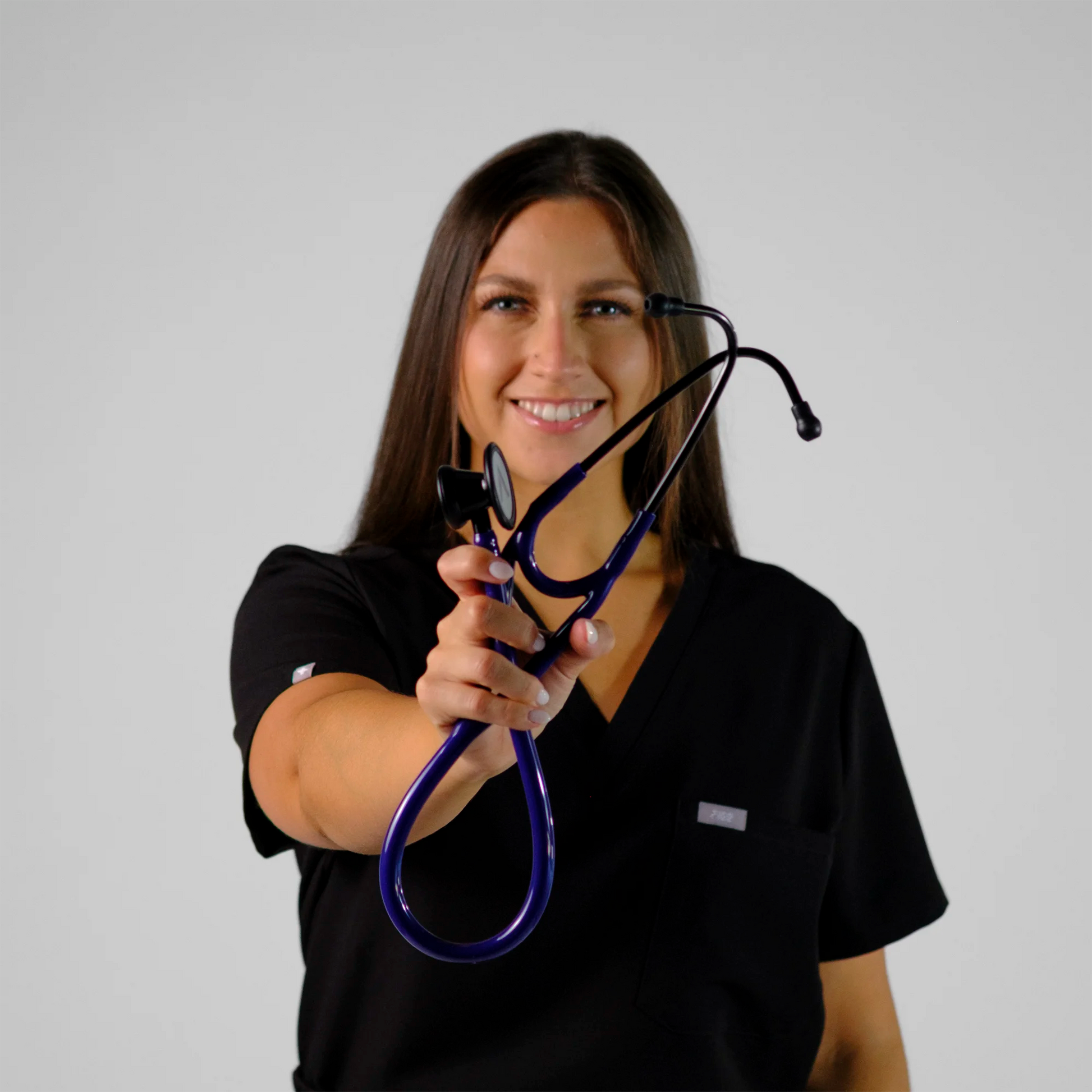 model holding a purple cardiology stethoscope
