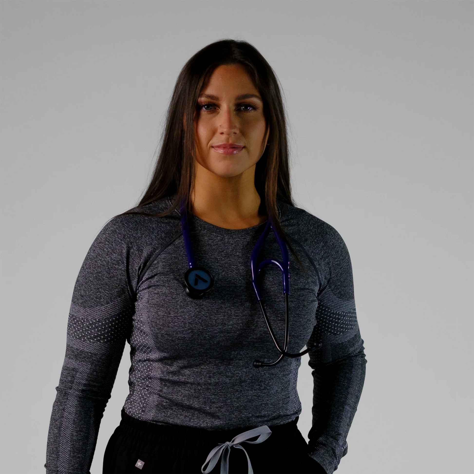 model wearing a purple cardiology stethoscope