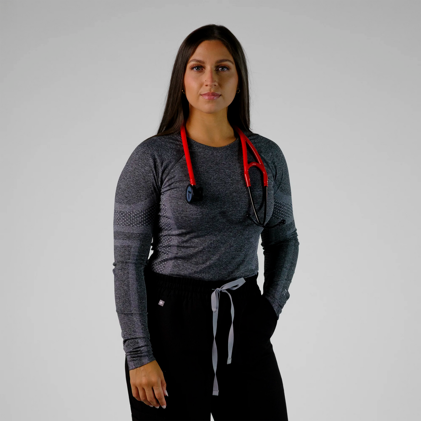 model posing with a red cardiology stethoscope