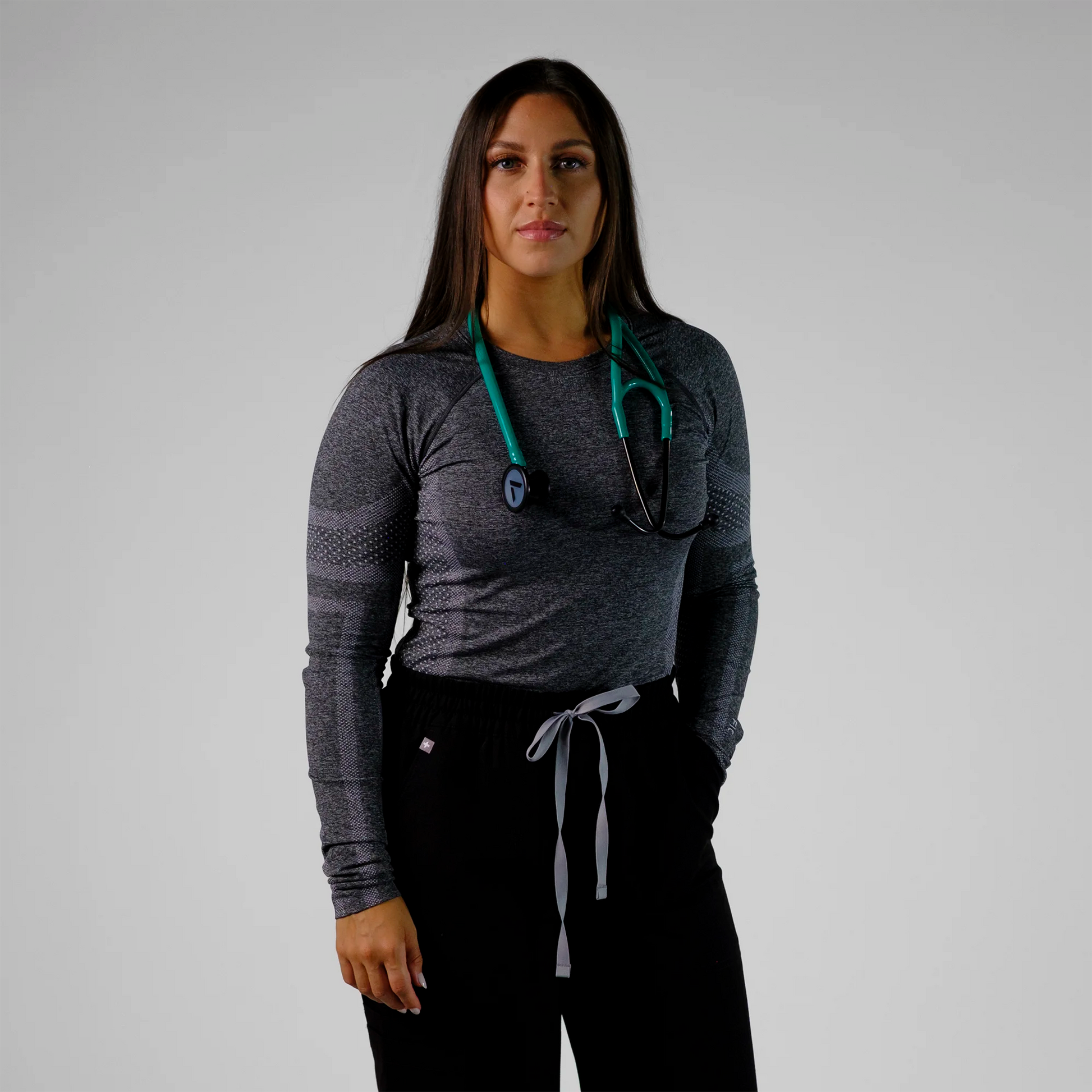 model posing with a teal cardiology stethoscope