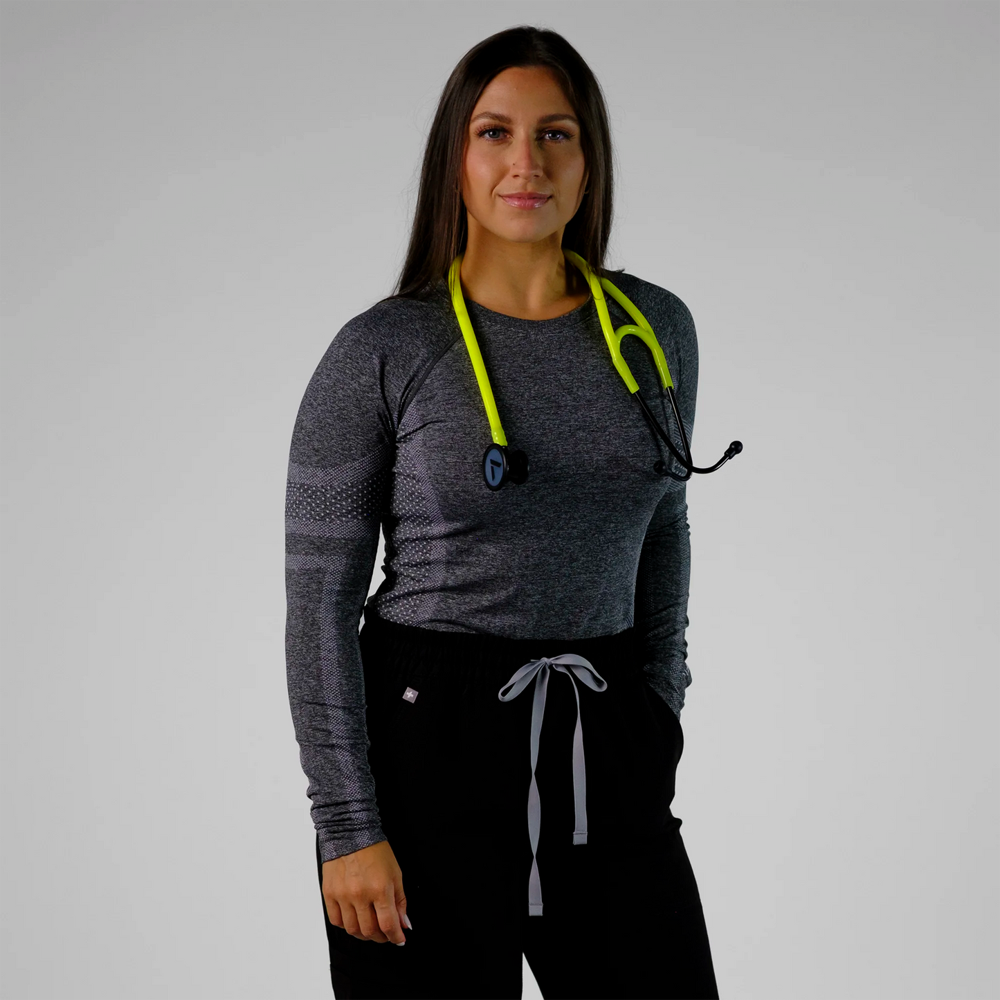 model posing with neon yellow cardiology stethoscope