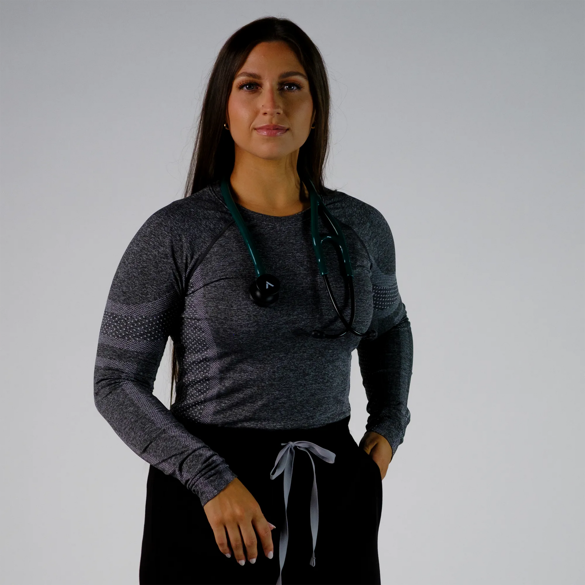 a model posing with  a teal cardiology stethoscope